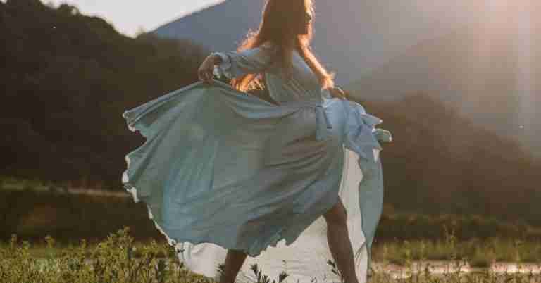 Woman Dancing Outside In White Dress